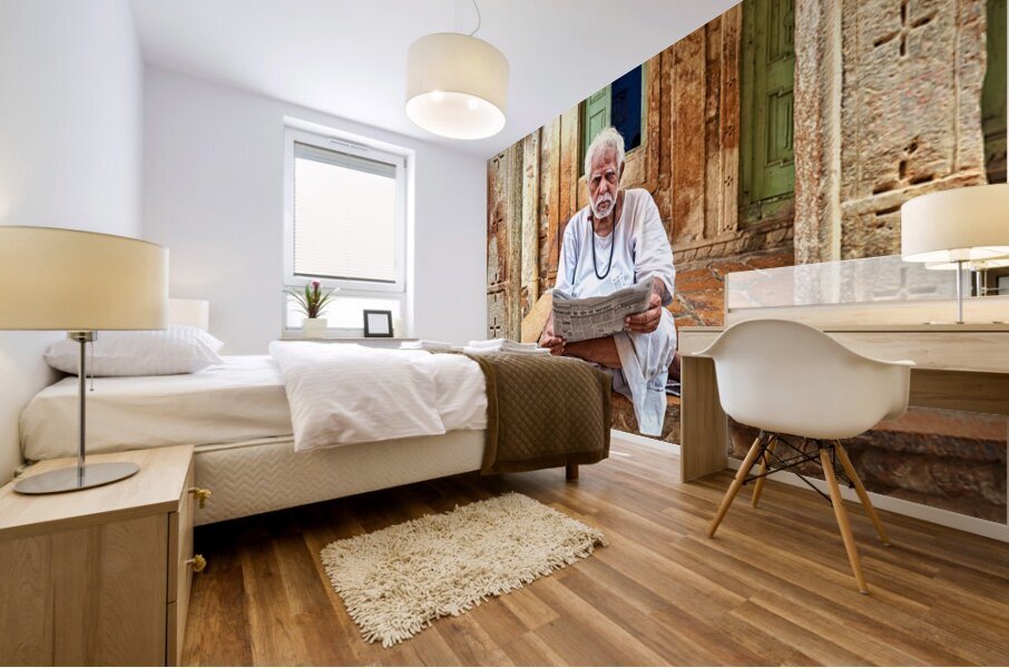 Man reads newspaper on street in Jaisalmer Rajasthan India Mural print