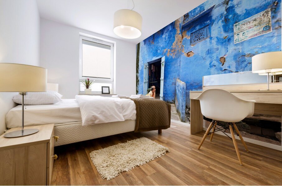 Man sweeps in front of home in Bundi Rajasthan during the day Mural print