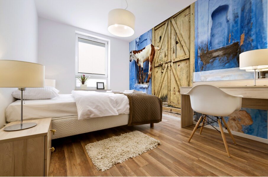 Goat standing on a wall by a wooden door in Bundi Rajasthan Mural print