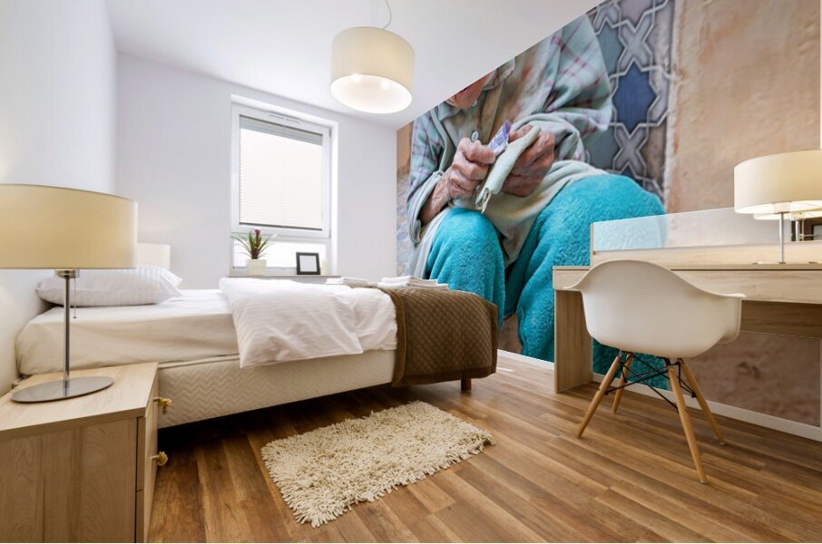 Beggar sitting in Fez Morocco with worn clothes and hands Mural print