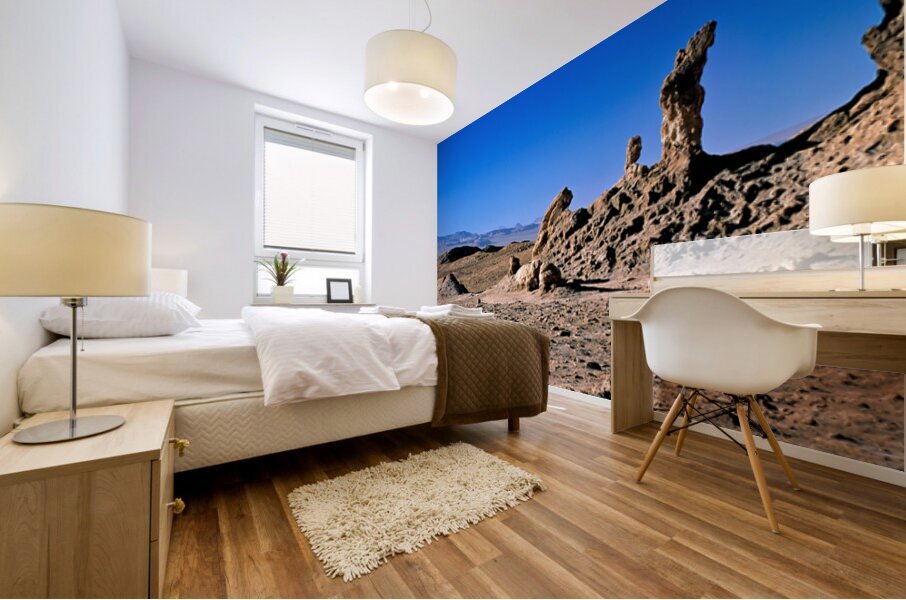 Arid desert with unusual rock pillars against a blue sky. Mural print