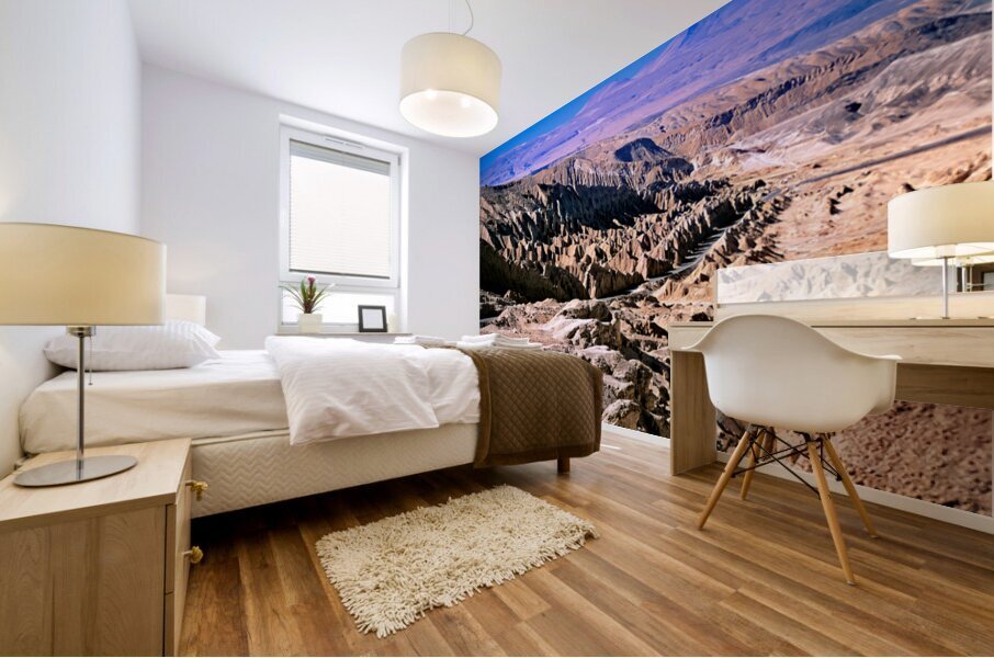 Eroded desert landscape with a road winding through mountains. Mural print