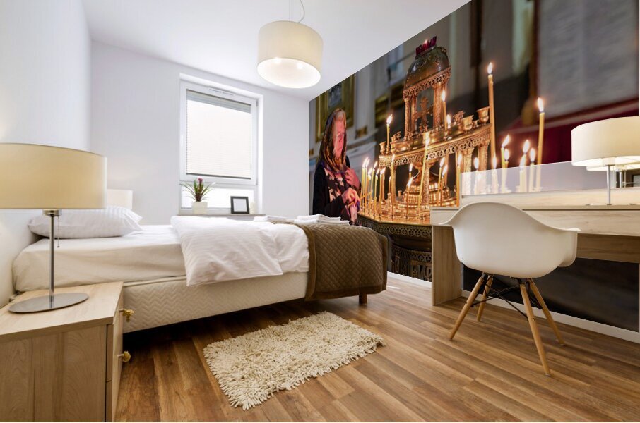 Woman lights candles at Alexander Nevsky Lavra Mural print