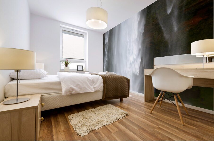 Woman walks near Seljalandsfoss waterfall in Iceland Mural print