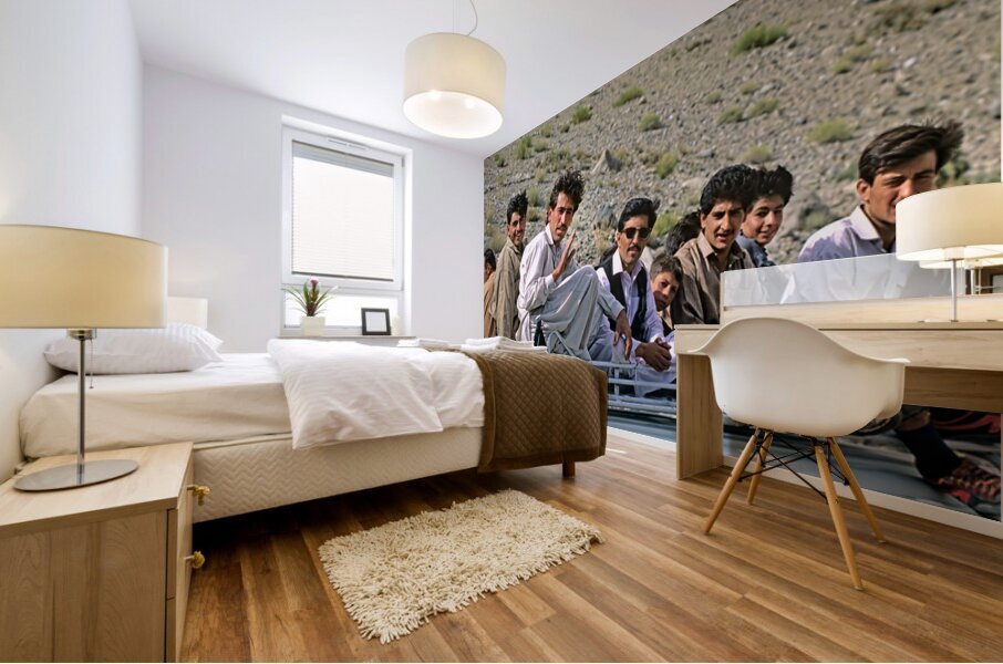 Group traveling on top of a van in Pakistans mountains Mural print