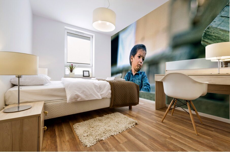 Sad boy sitting on stairs in Lahore Pakistan during the day Mural print