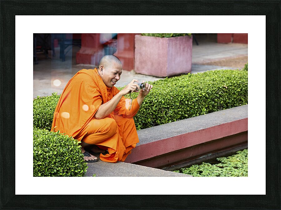 A buddhist monk taking a picture at the National Museum of Cambodia in Phnom Penh Picture Frame print