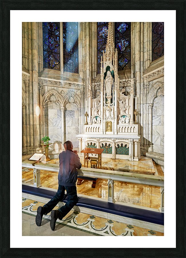 New York. Manhattan. United States. St. Patricks cathedral. A faithful prays in a chapel Picture Frame print