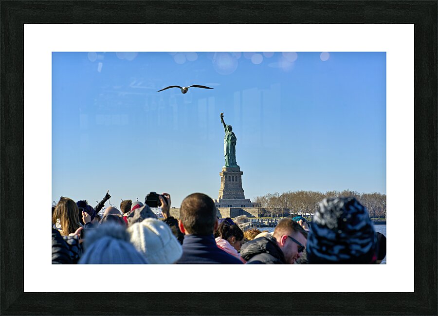 New York. Manhattan. United States. Tourists approaching Liberty Island by ferry Picture Frame print