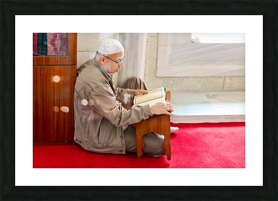 Istanbul Turkey. Muslim believer praying and reading Koran in the Fatih Mosque Picture Frame print