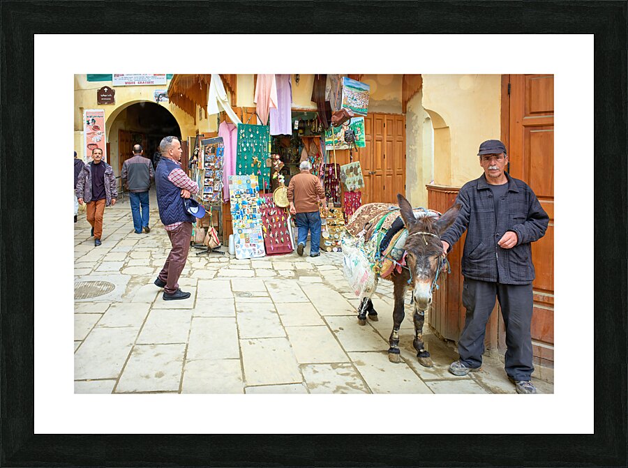 Morocco Fez. A man with his donkey in the medina Picture Frame print