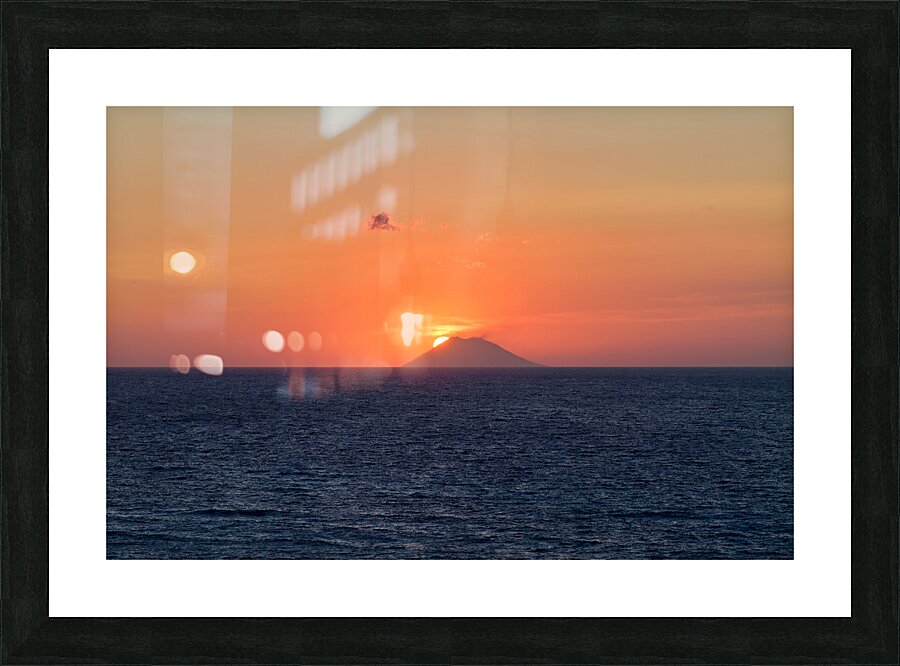 Tropea Calabria Italy. The sun sets in the crater mouth of Stromboli volcano Picture Frame print