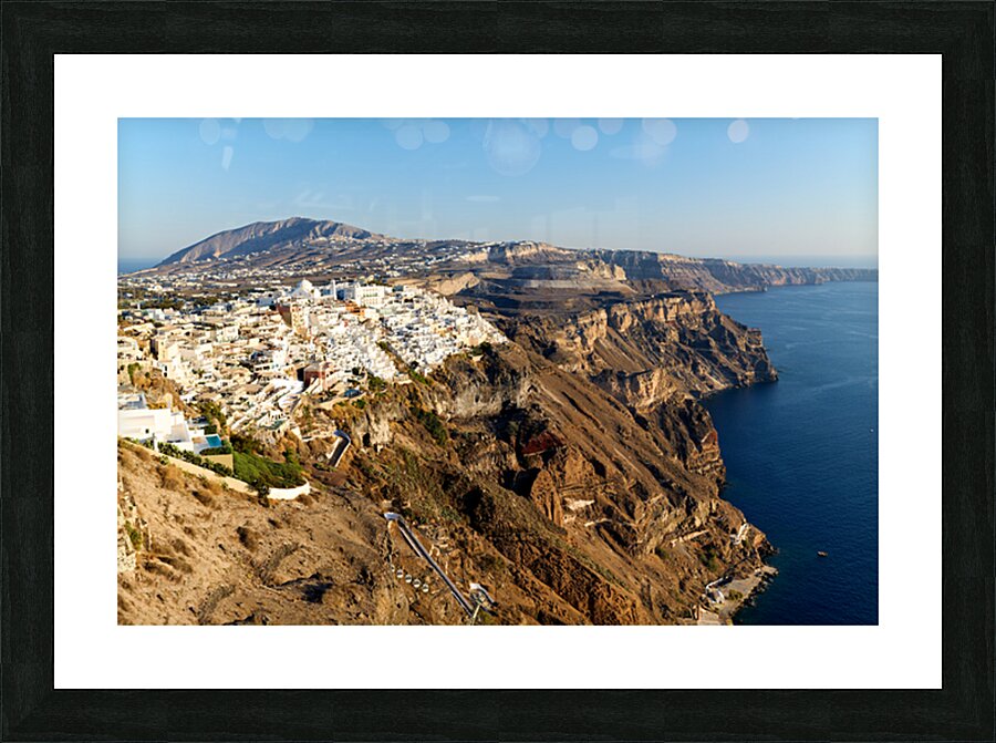 Santorinis white buildings on caldera cliffs above the sea. Picture Frame print
