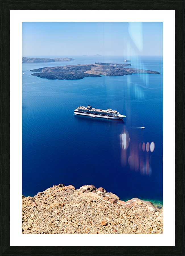 Cruise ship in deep blue sea volcanic islands rocky foreground Picture Frame print