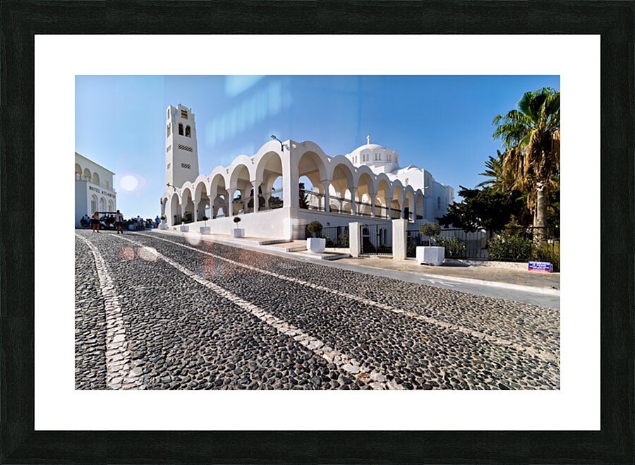 Beautiful white church and cobblestone street in sunny Santorini Picture Frame print