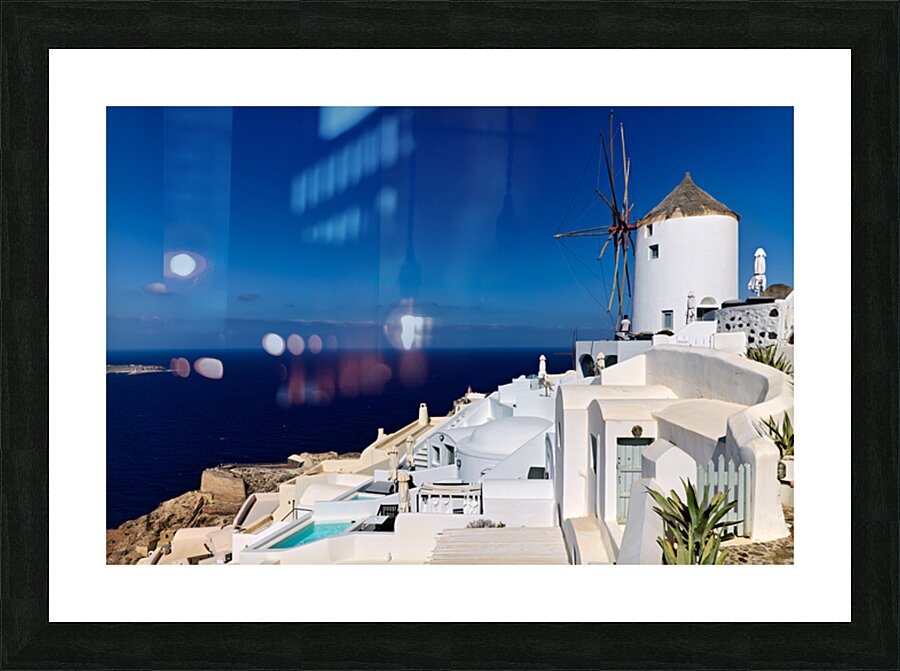 Santorinis iconic white architecture and windmill against the d Picture Frame print