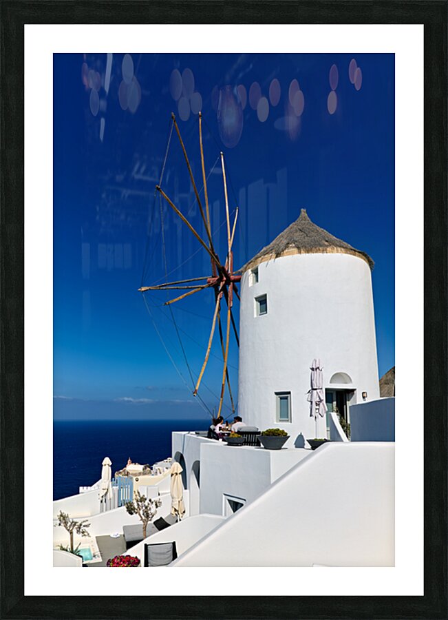Santorini windmill and white architecture overlooking the blue s Picture Frame print