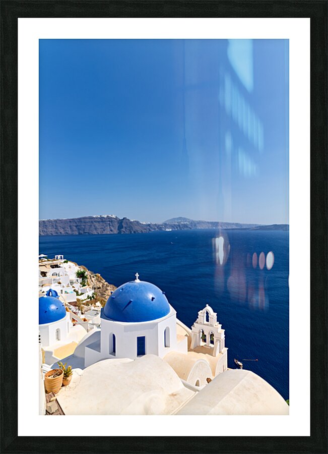 Iconic blue domes and white architecture of Santorini Greece. Picture Frame print