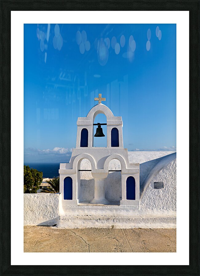 White bell tower against blue sky and sea. Picture Frame print