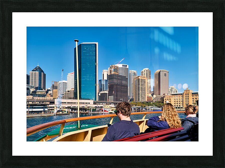 Ferry passengers enjoy city skyline view. Picture Frame print