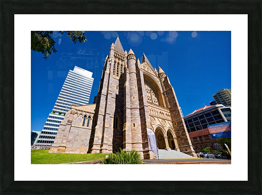 Historic church stands tall next to modern skyscrapers. Picture Frame print