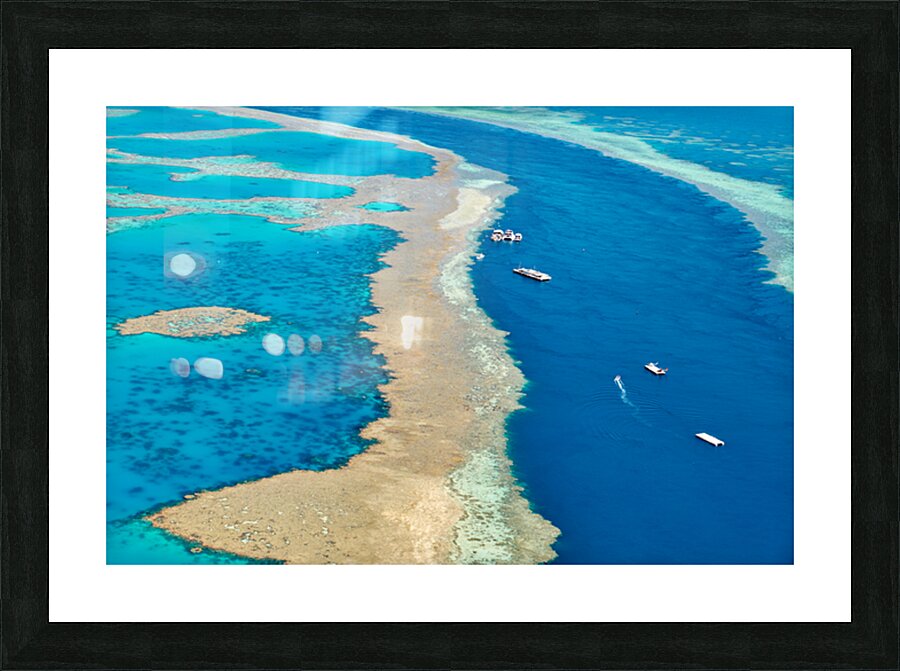 Aerial view of coral reefs and boats in turquoise ocean. Picture Frame print