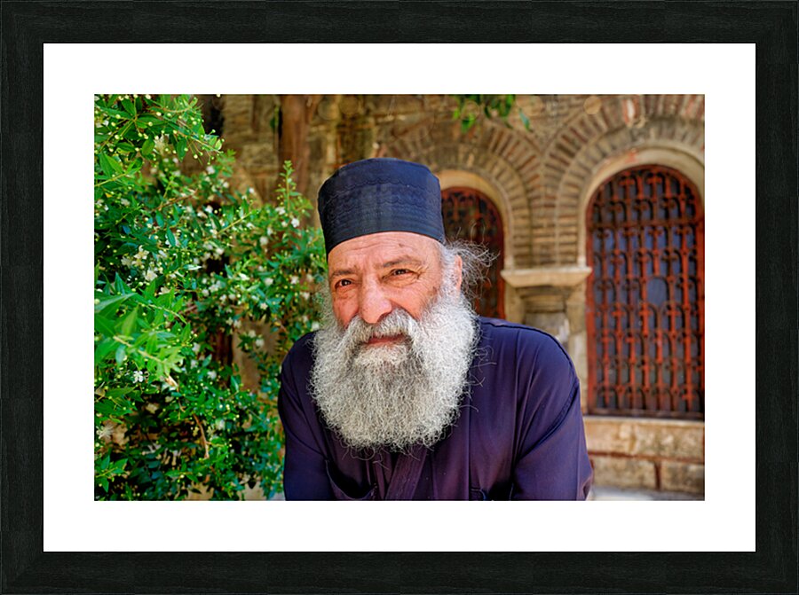 Elderly man with a beard poses near a historical building in a g Picture Frame print