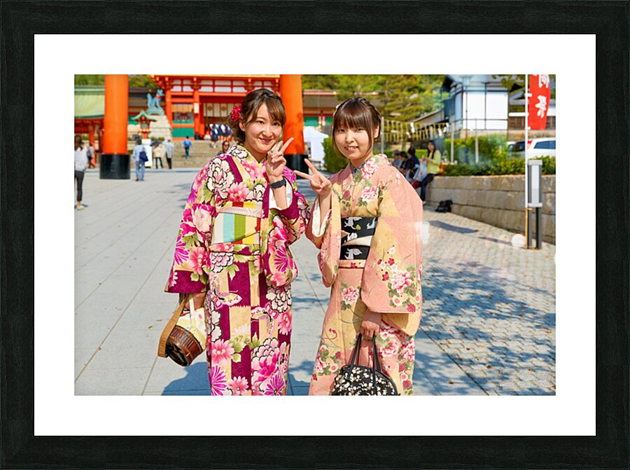 Young women enjoy Fushimi Inari Taisha Shrine in Kyoto Japan Picture Frame print