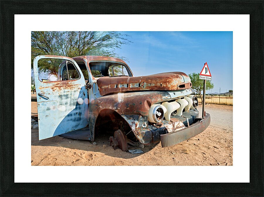 Classic car wreck in Namibias desert environment Picture Frame print