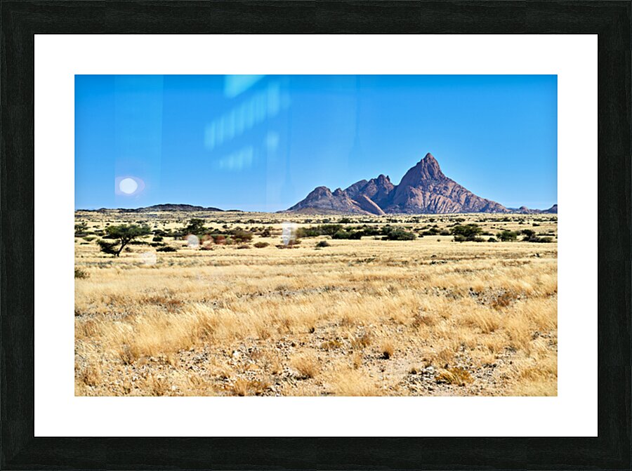 Granite peaks of Spizkoppe rise above the Namib Desert in Namibi Picture Frame print