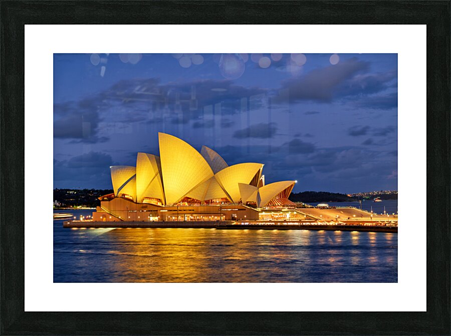 Sydney Opera House illuminated at dusk with harbor lights. Picture Frame print