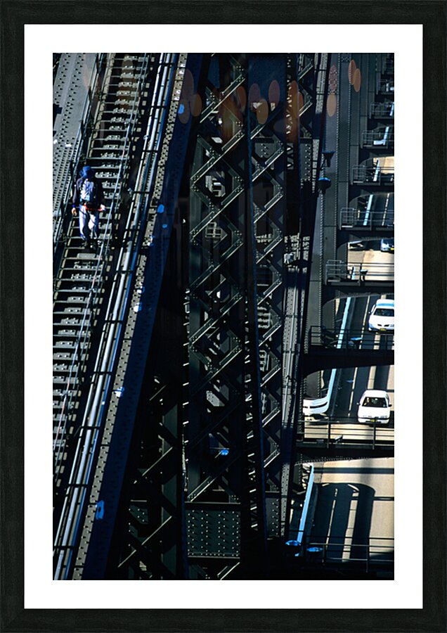 Man walks on bridge with cars below Picture Frame print