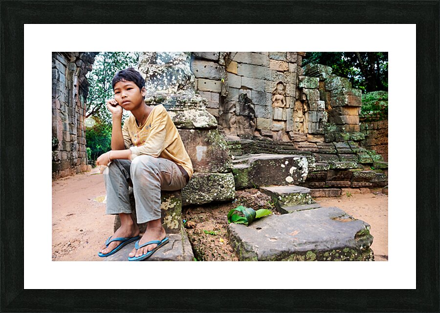 Young person sits on ancient temple ruins. Picture Frame print