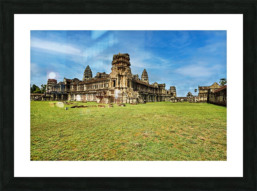 Angkor Wat temple complex with green grass and blue sky. Picture Frame print