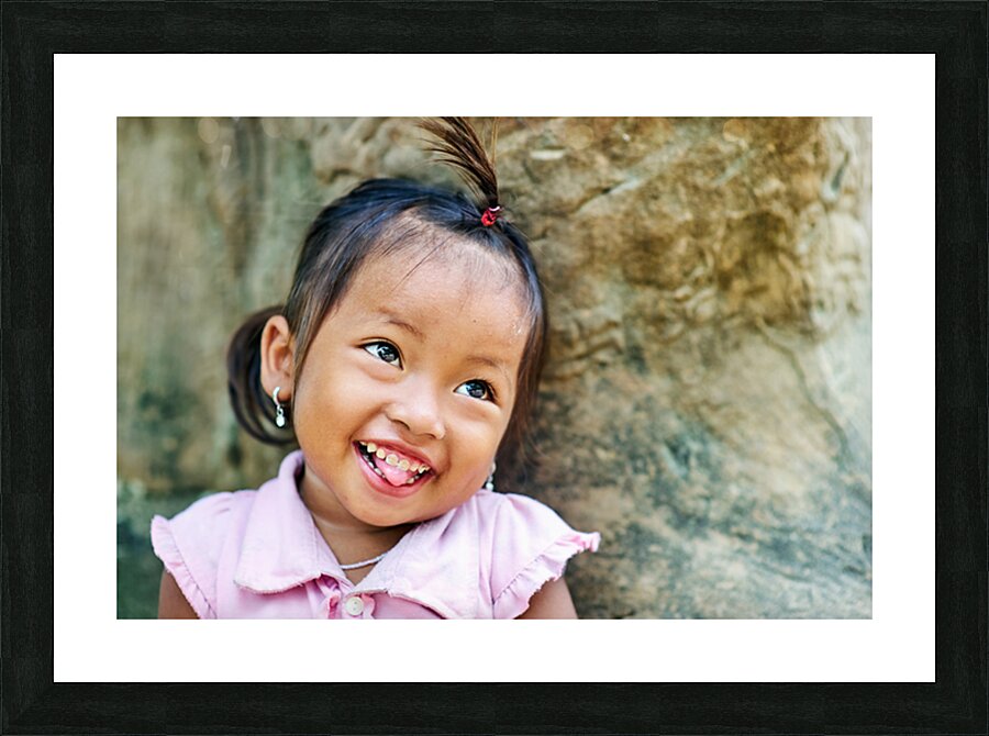 Joyful young girl with a playful smile and tongue out. Picture Frame print