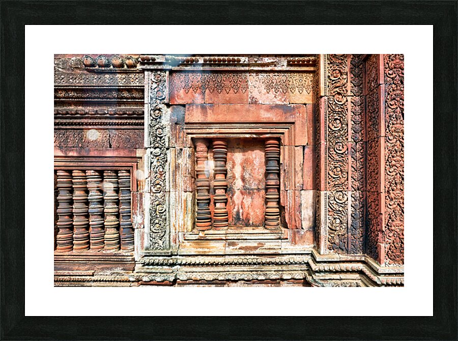 Ancient temple wall with intricate reddish stone carvings and co Picture Frame print