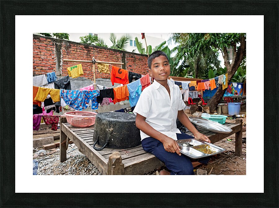 Boy with food tray clothes drying in background. Picture Frame print