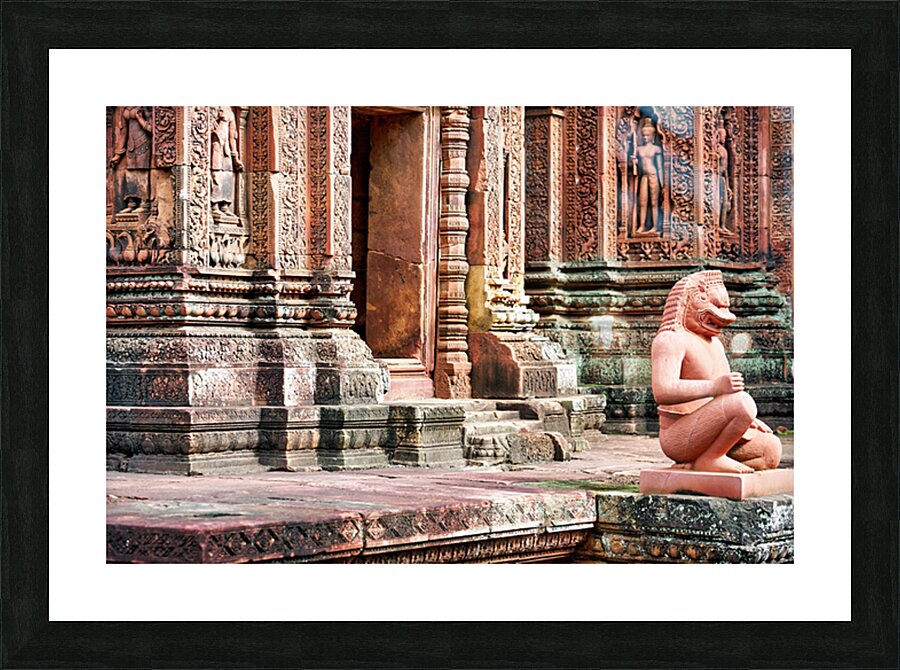 Ancient Cambodian temple with intricate carvings and guardian st Picture Frame print