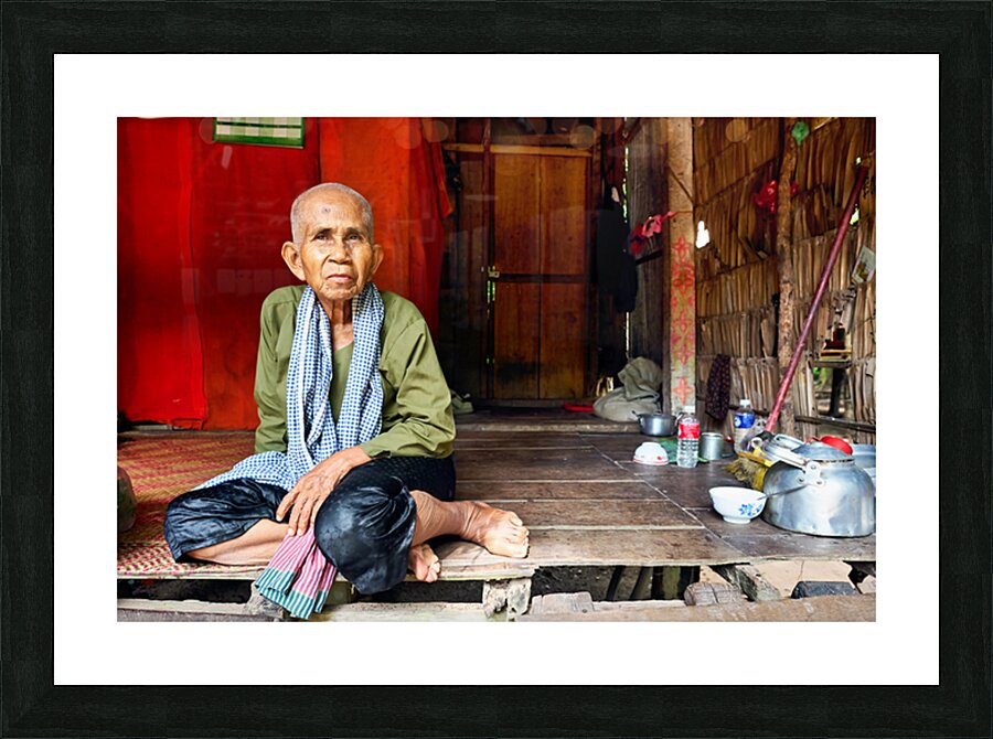 Elderly person sitting on floor in rustic dwelling. Picture Frame print