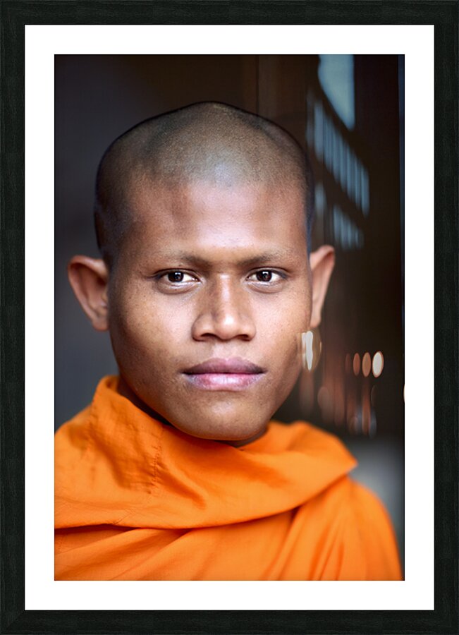 Young Buddhist monk in orange robe close up portrait. Picture Frame print