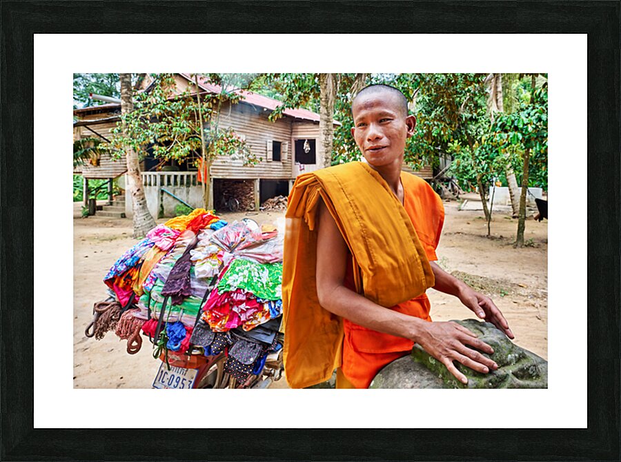 Monk with colorful textiles on a motorcycle. Picture Frame print