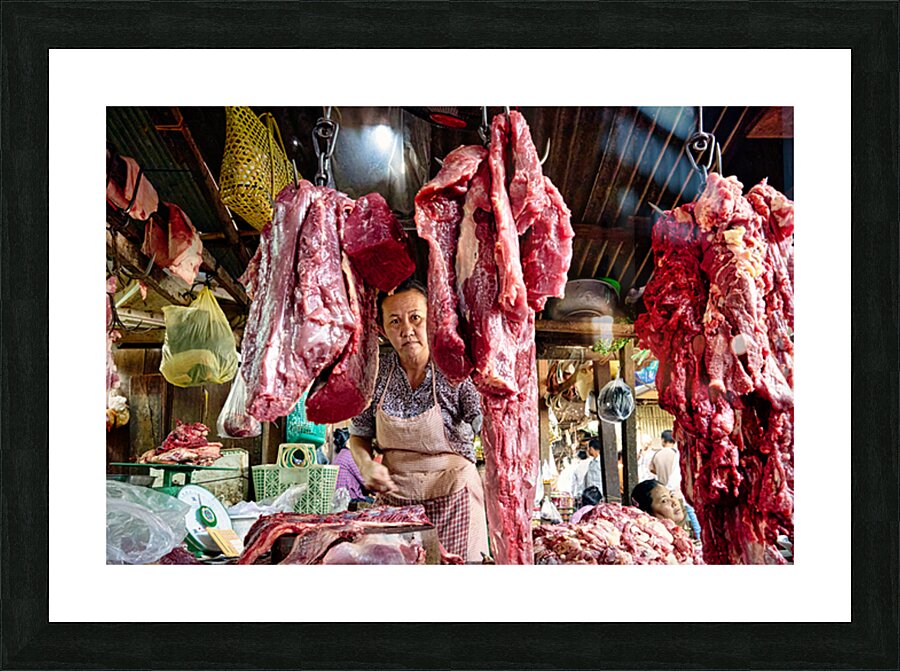 Woman selling raw meat in a bustling market. Picture Frame print