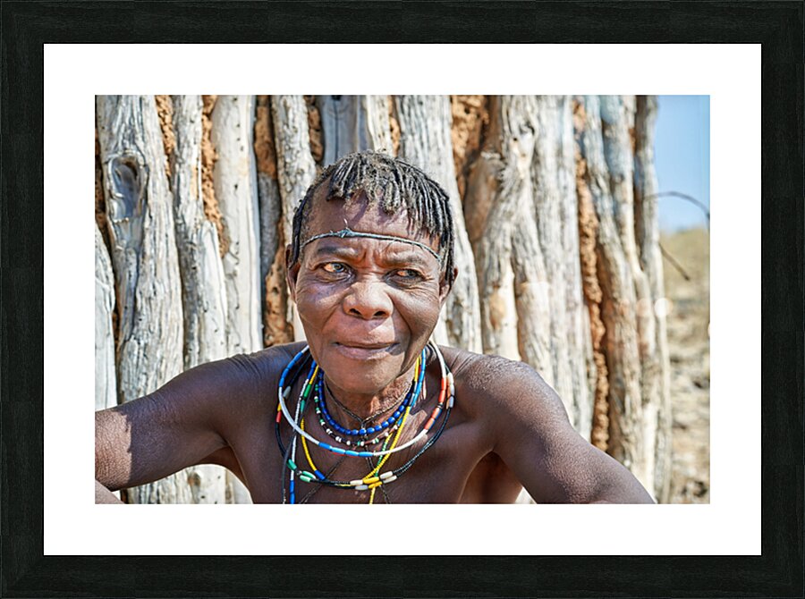 Old woman of Zemba Bantu ethnic group sits near wooden wall in N Picture Frame print