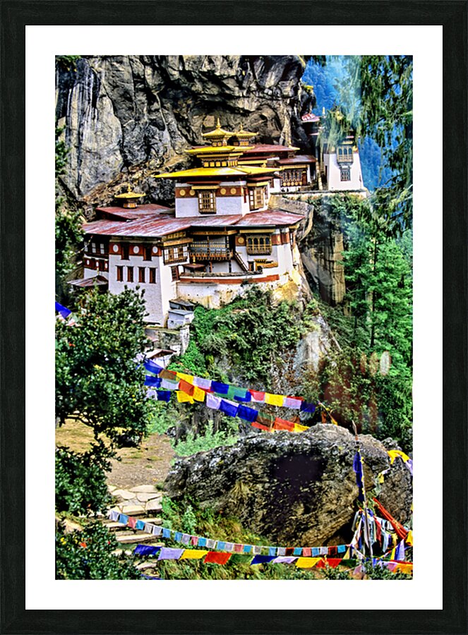 Iconic Bhutanese monastery on a cliff surrounded by prayer flag Picture Frame print