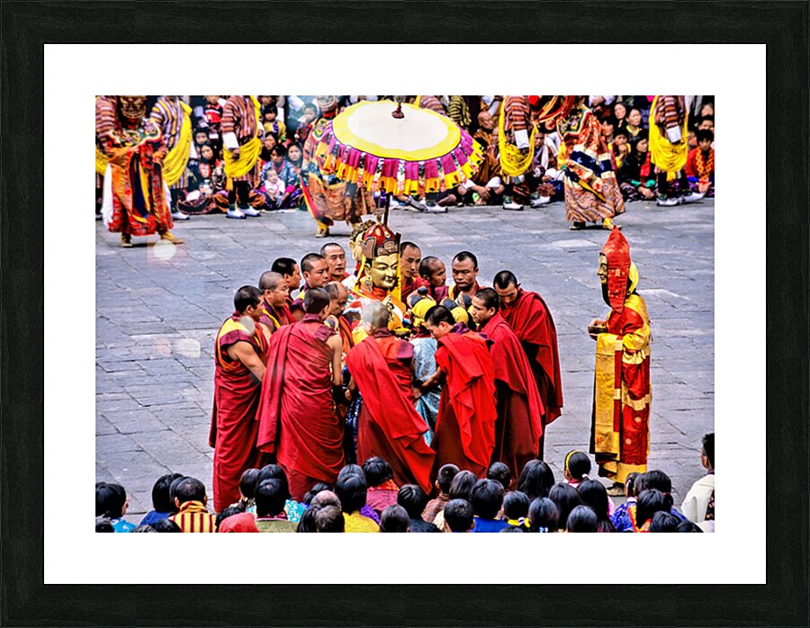 Monks in red robes gathered around a golden statue. Picture Frame print