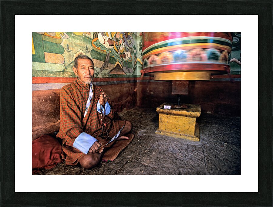 Bhutanese man with prayer beads and spinning prayer wheel. Picture Frame print