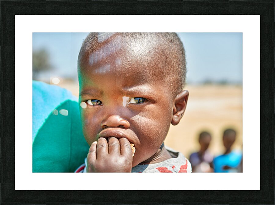Sad boy in Kavango Region of Namibia looks thoughtful and lost Picture Frame print