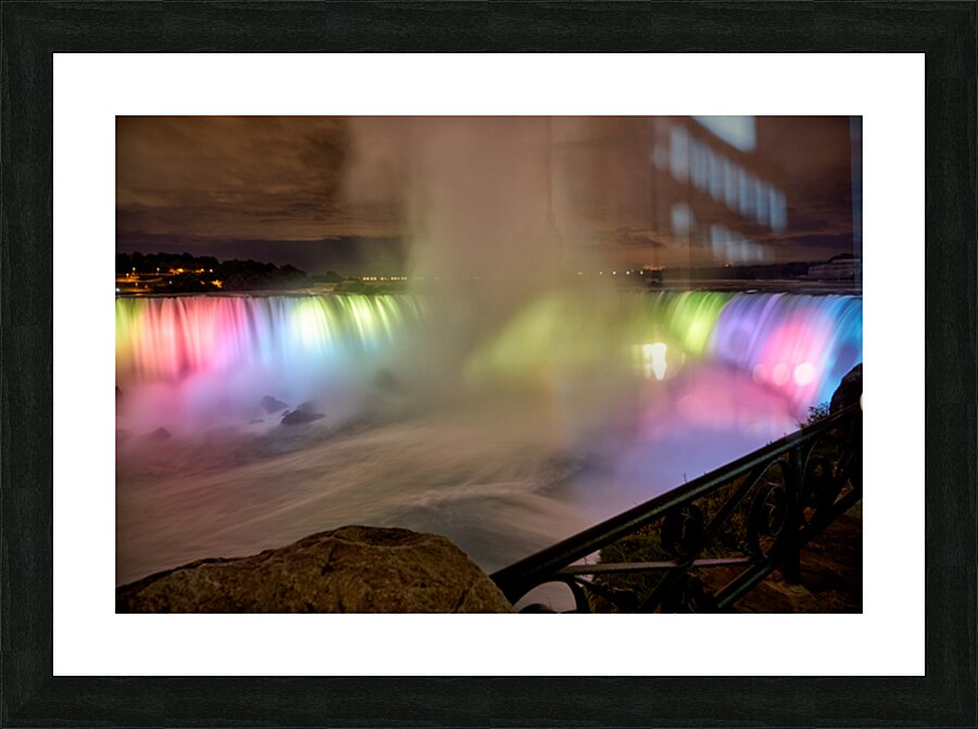 Niagara Falls illuminated at night with colorful lights. Picture Frame print