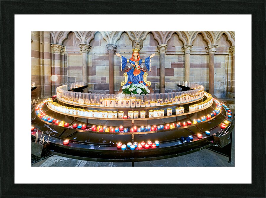 Visitors light votive candles near statue in Strasbourg Cathedra Picture Frame print