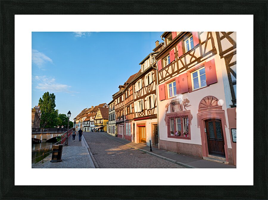 People walking along the canal in Petite Venise Colmar during ev Picture Frame print